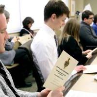 Students reviewing the pamphlet